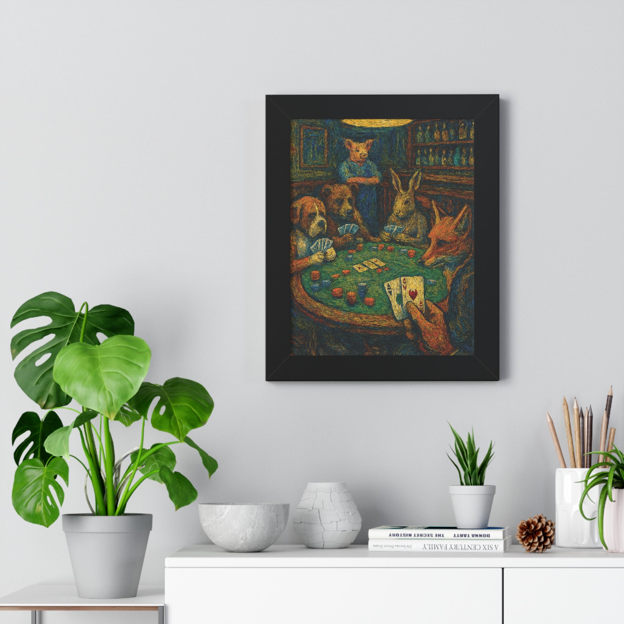 Framed artwork of animals playing poker on a wall above a white cabinet with decorative items.